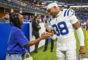 NFL fans react Simone Biles and Jonathan Owens make pinky promise gesture ahead of Colts vs. Commanders game